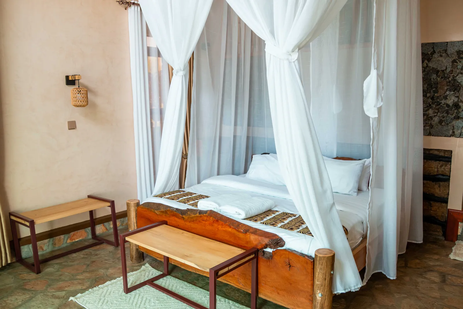 Bright guest room with a locally crafted timber bed and mosquito net